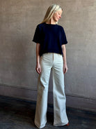 Mature woman waring the Slouchy Rolled Tee Top from TWP luxury women's designer tee rendered in a versatile navy blue and crafted from 100% cotton with short sleeves and crew neckline