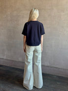 Mature woman waring the Slouchy Rolled Tee Top from TWP luxury women's designer tee rendered in a versatile navy blue and crafted from 100% cotton with short sleeves and crew neckline