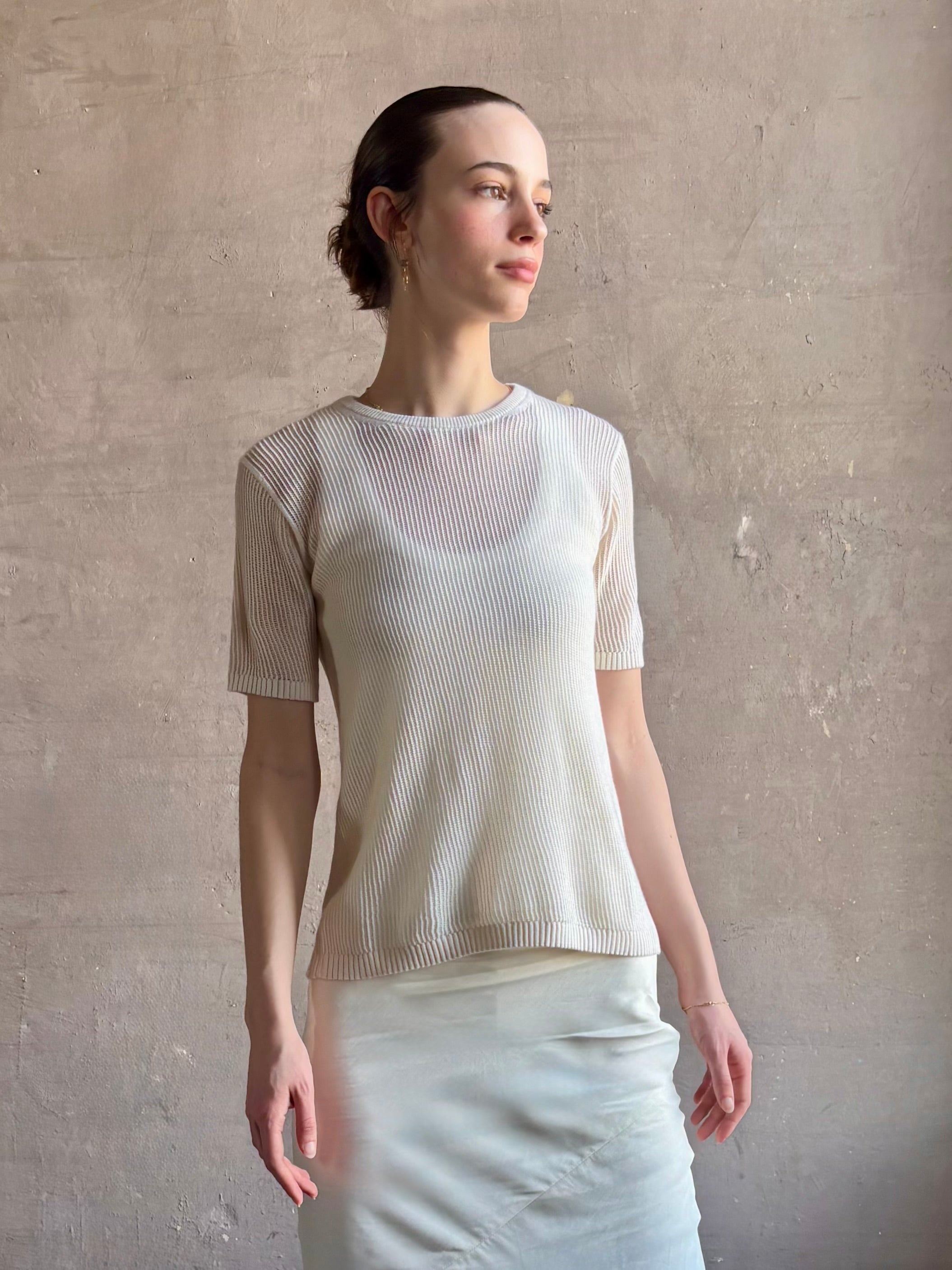 Woman wearing luxury designer TWP Short Sleeve premium knit lightweight cashmere Tee top in Ivory with crew neck and short sleeves