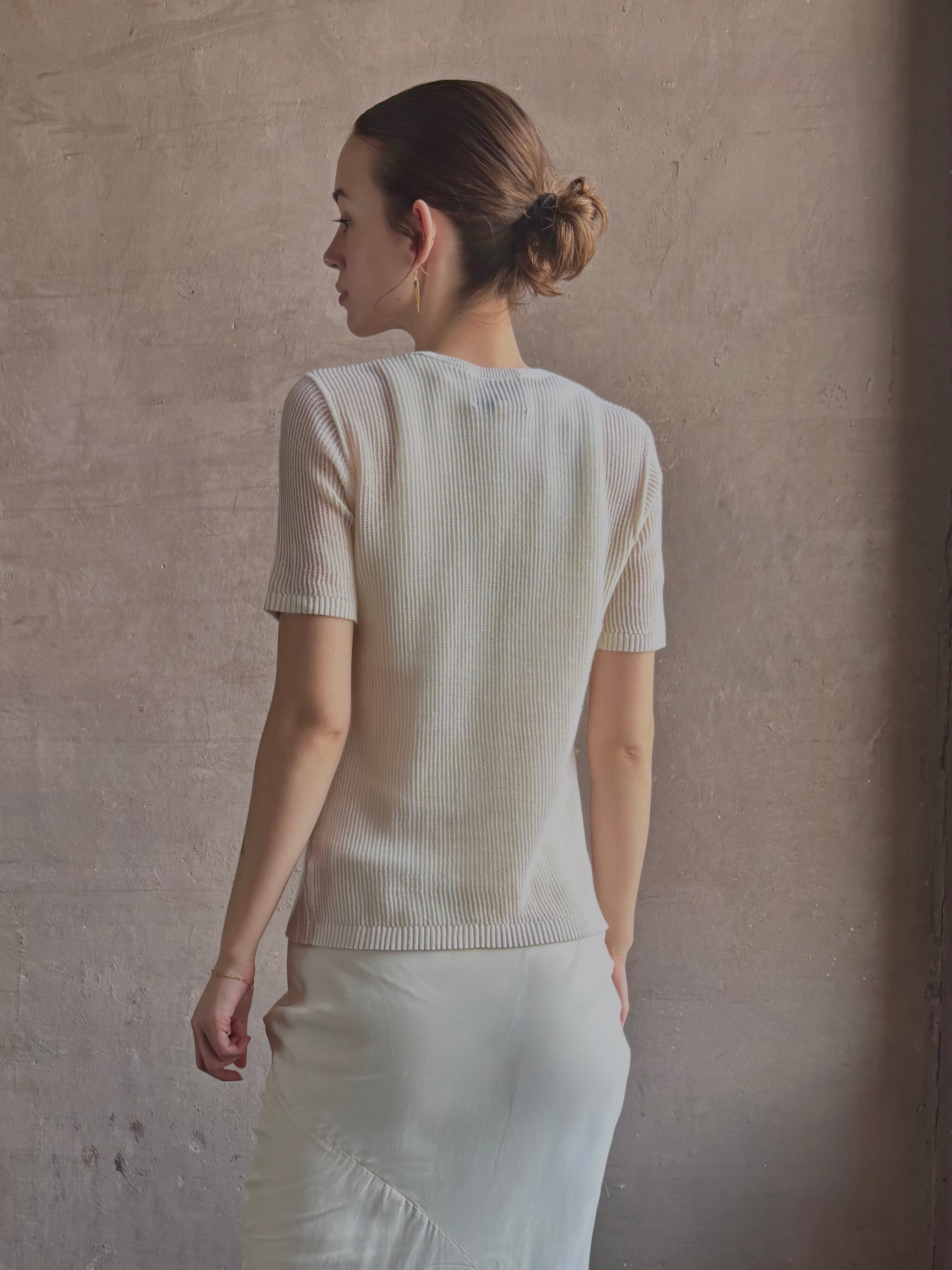 Woman wearing luxury designer TWP Short Sleeve premium knit lightweight cashmere Tee top in Ivory with crew neck and short sleeves