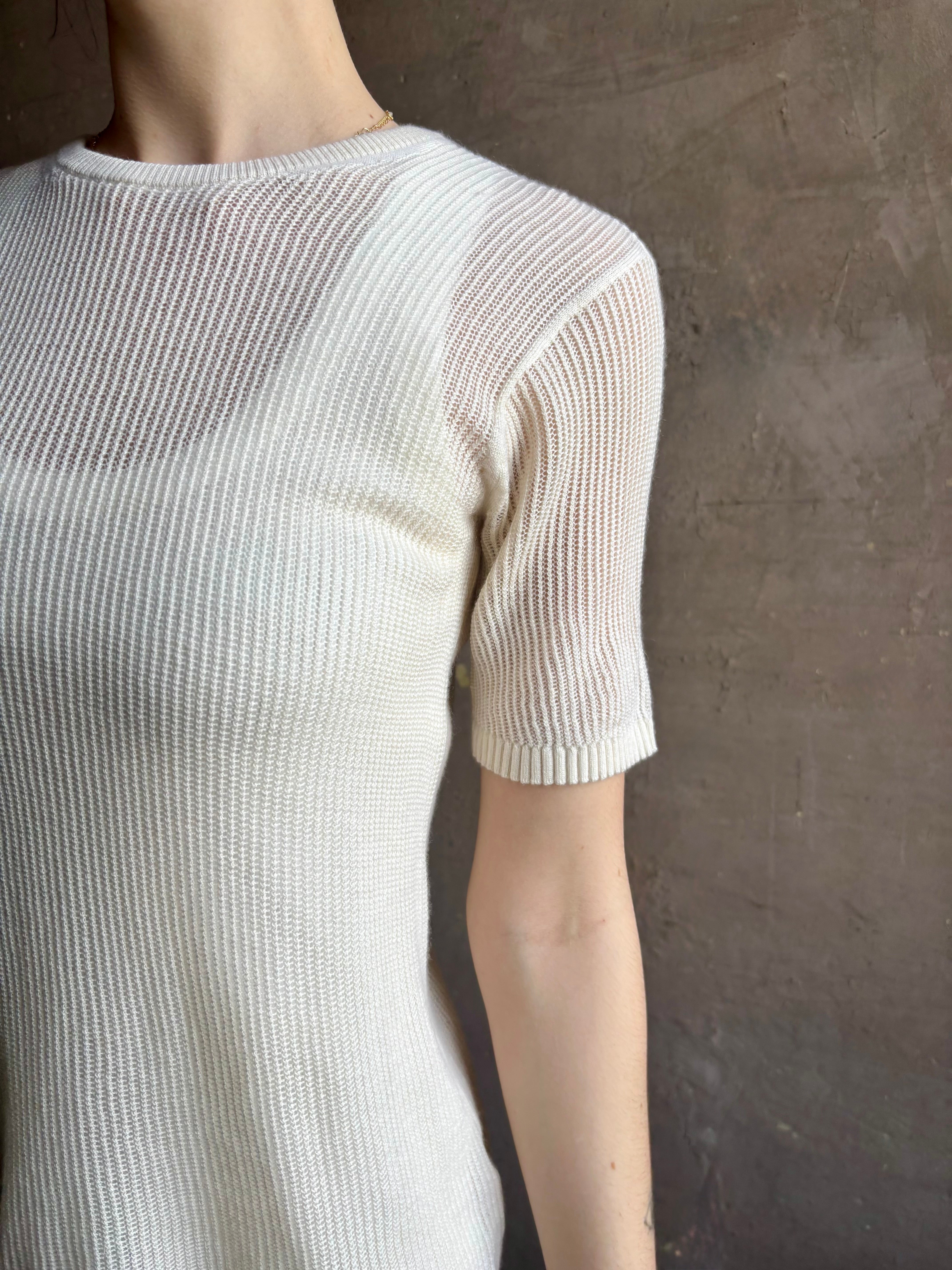 Woman wearing luxury designer TWP Short Sleeve fine knit lightweight cashmere Tee top in Ivory with crew neck and short sleeves