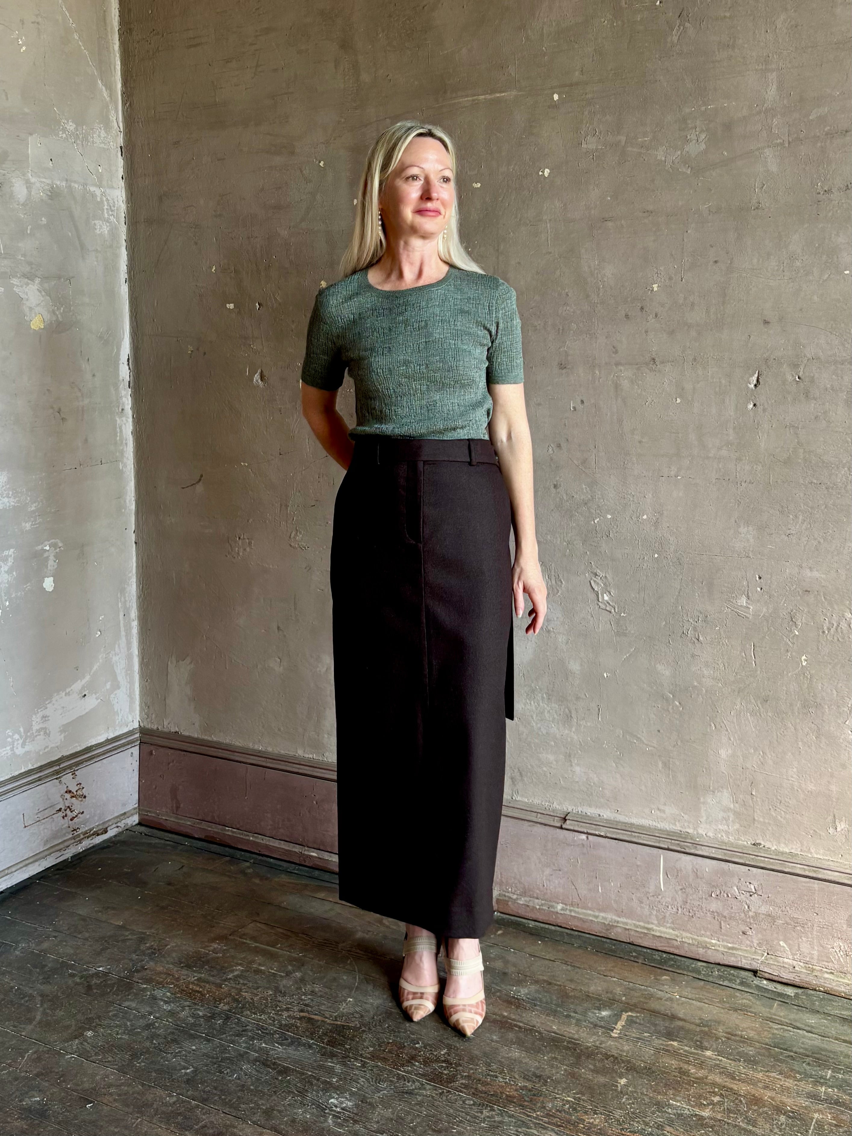 Mature woman wearing TWP's Slit Pencil Skirt in Chocolate Brown a sophisticated wool-cashmere blend with Tailored waist  American-made maxi