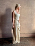 Mature woman wearing premium cotton TWP Tiny Dancer rigid denim with relaxed high rise and wide leg in Natural