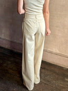 Mature woman wearing premium cotton TWP Tiny Dancer rigid denim with relaxed high rise and wide leg in Natural
