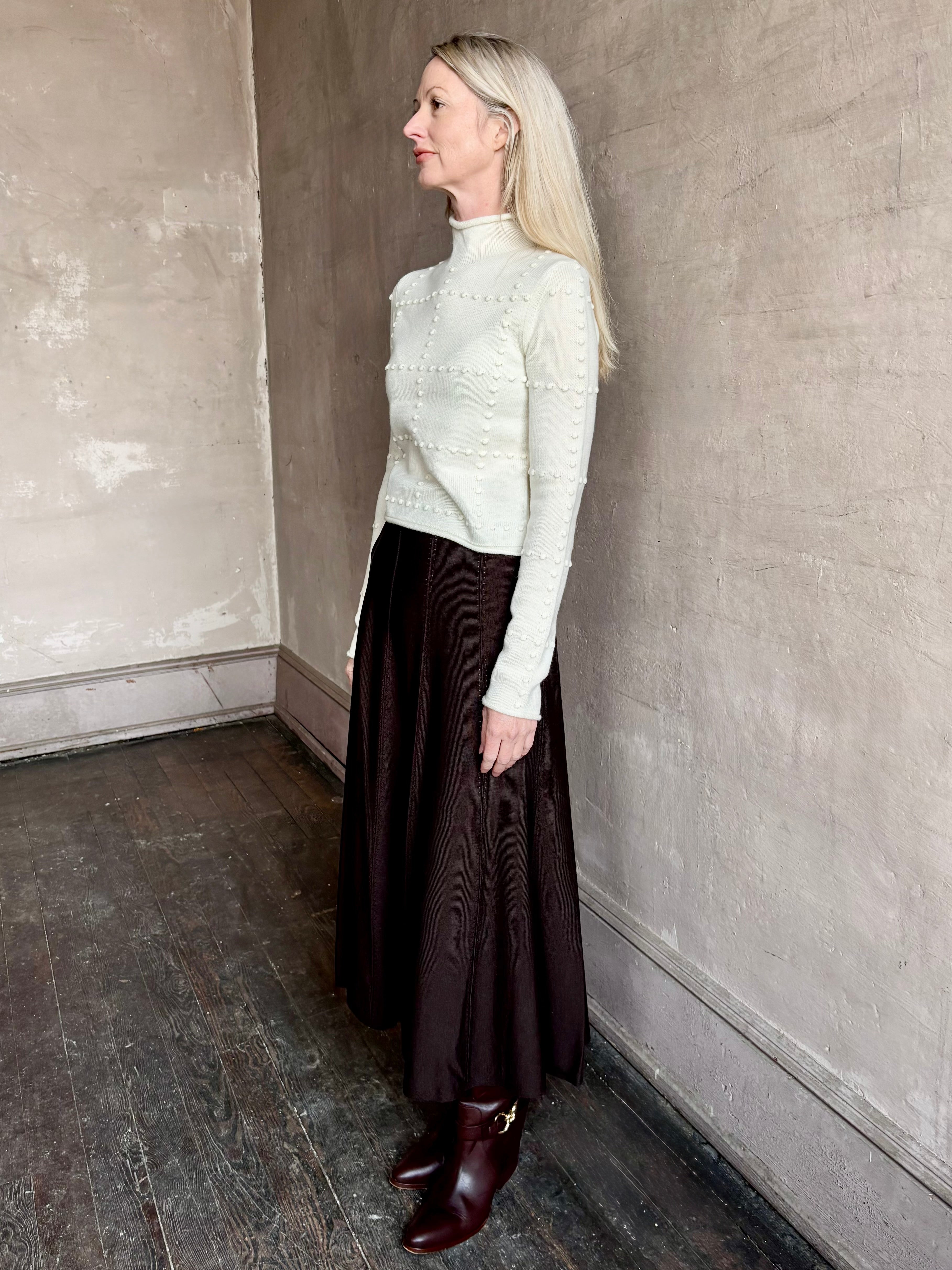 Woman wearing TWP Willow Knit Skirt in chocolate brown premium Merino Wool Knit A-line Skirt