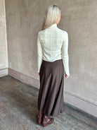 Woman wearing TWP Willow Knit Skirt in chocolate brown premium Merino Wool Knit A-line Skirt