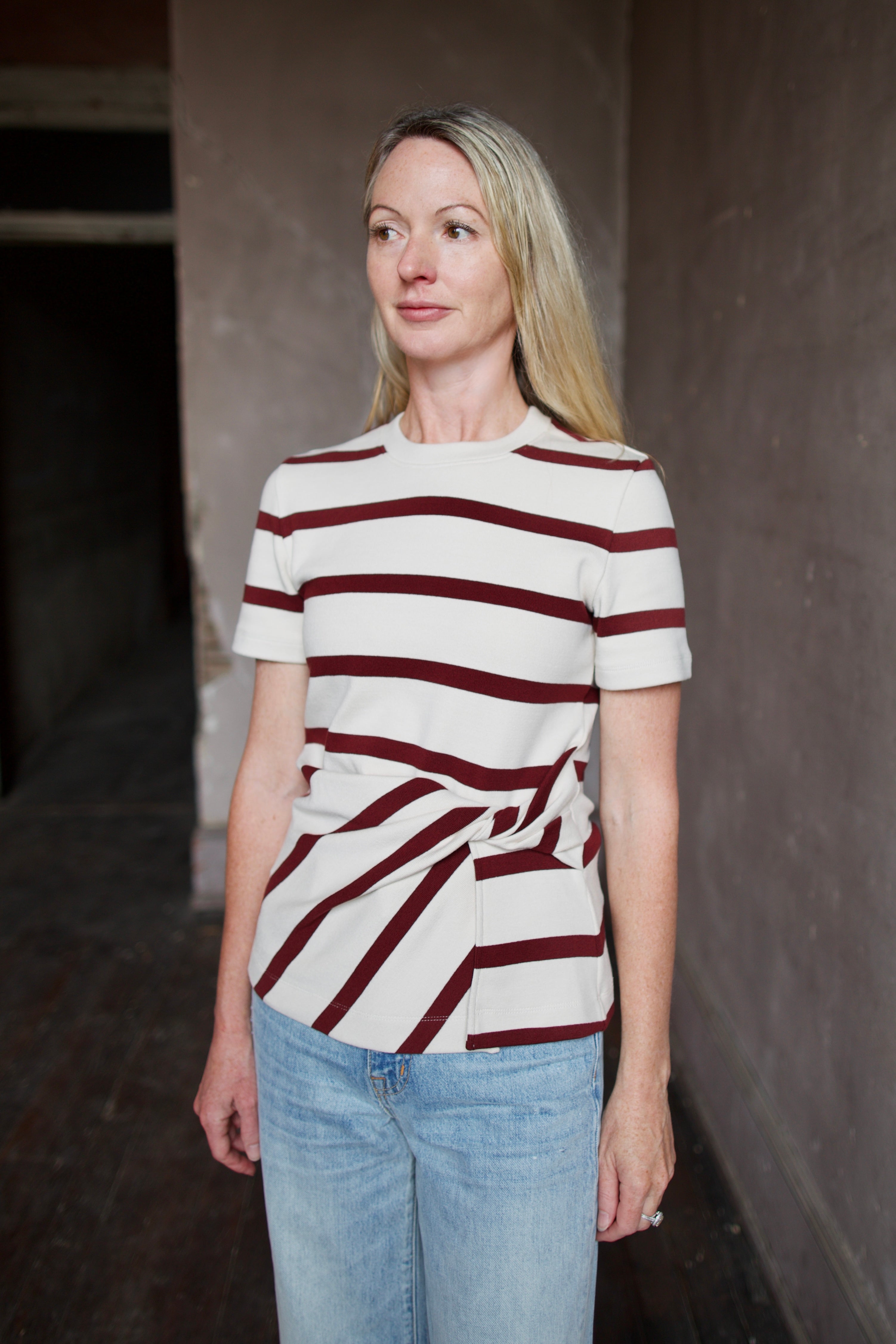 Mature model wearing a premium striped organic cotton t-shirt from Tanya Taylor with twist front