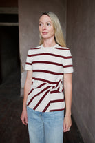 Mature model wearing a premium striped organic cotton t-shirt from Tanya Taylor with twist front