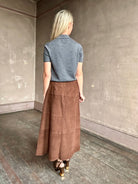 Image of woman wearing Tanya Taylor Camilla Knit top with a brown sequin floral patterned over a gray extra fine merino wool polo sweater