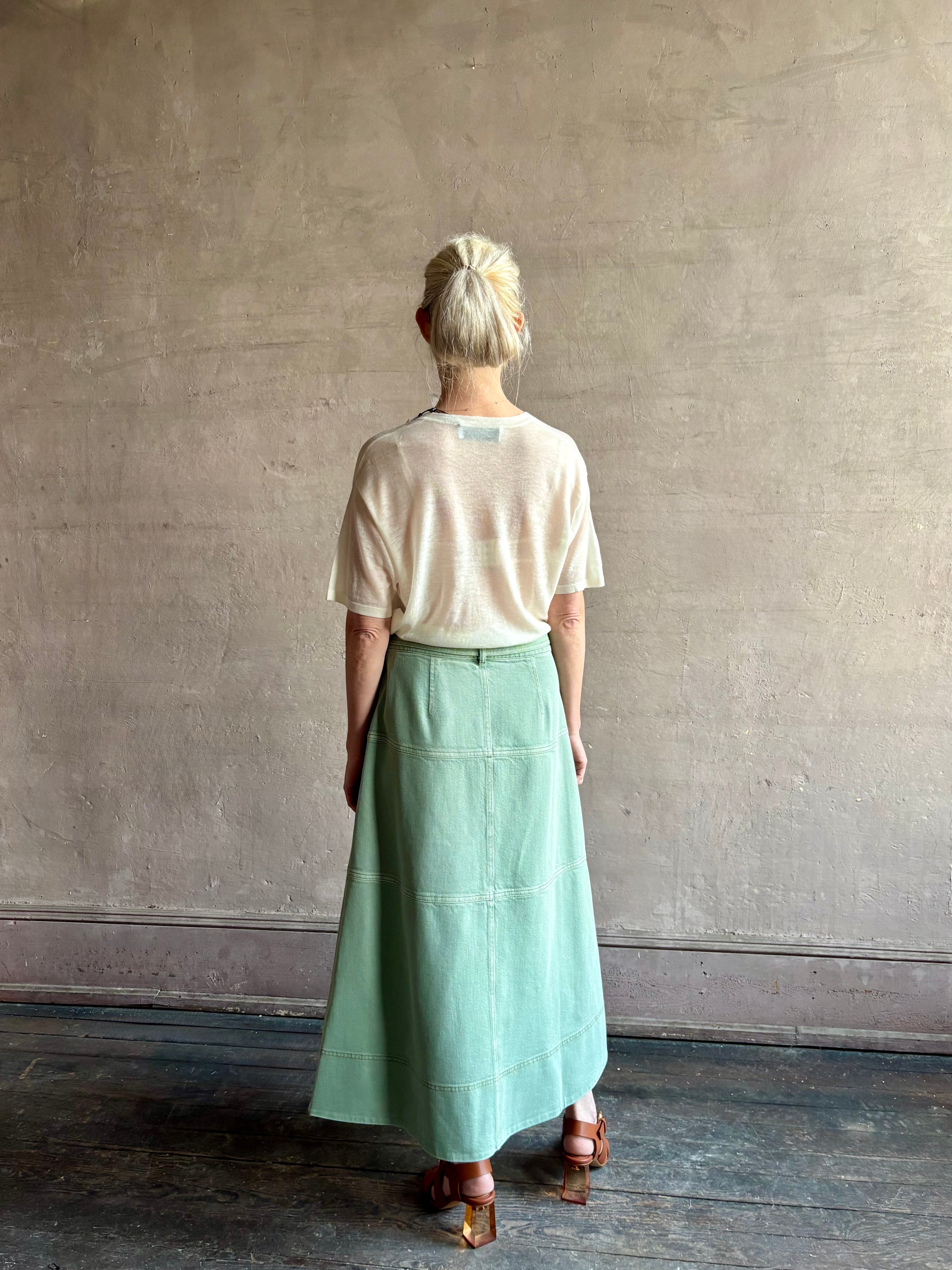 woman wearing premium designer Tanya Taylor Hudley tiered cotton maxi A-line Skirt in Pistachio green