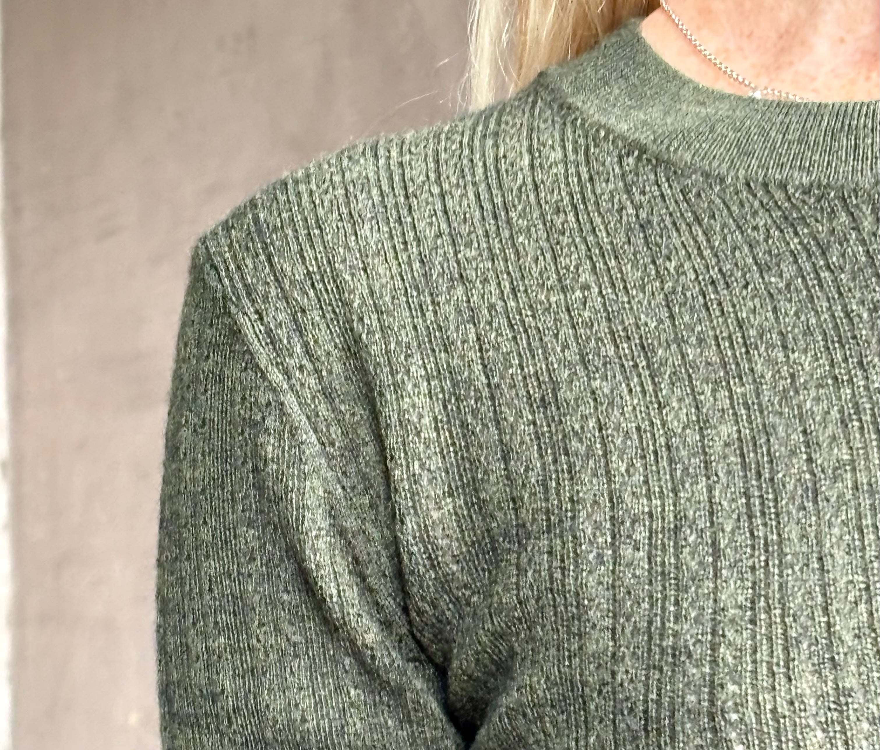 Close up image of designer TANYA TAYLOR Crew Neck Kayden merino wool Knit Top in sophisticated heathered Green