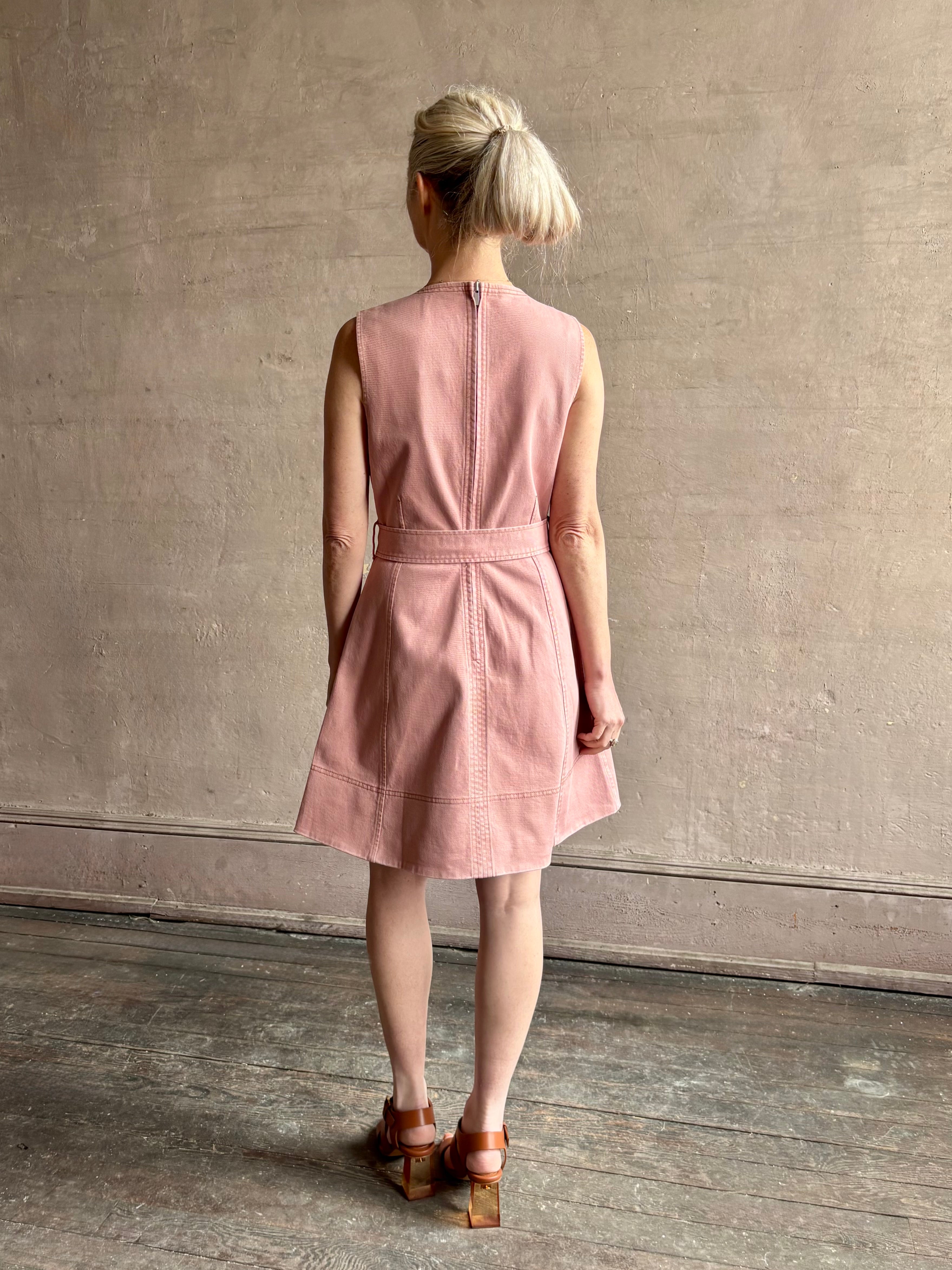 mature woman wearing designer Tanya Taylor Reina cotton denim short sleeveless Dress in Roqua pink with v-neck and expert tailoring