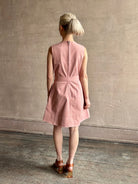 mature woman wearing designer Tanya Taylor Reina cotton denim short sleeveless Dress in Roqua pink with v-neck and expert tailoring