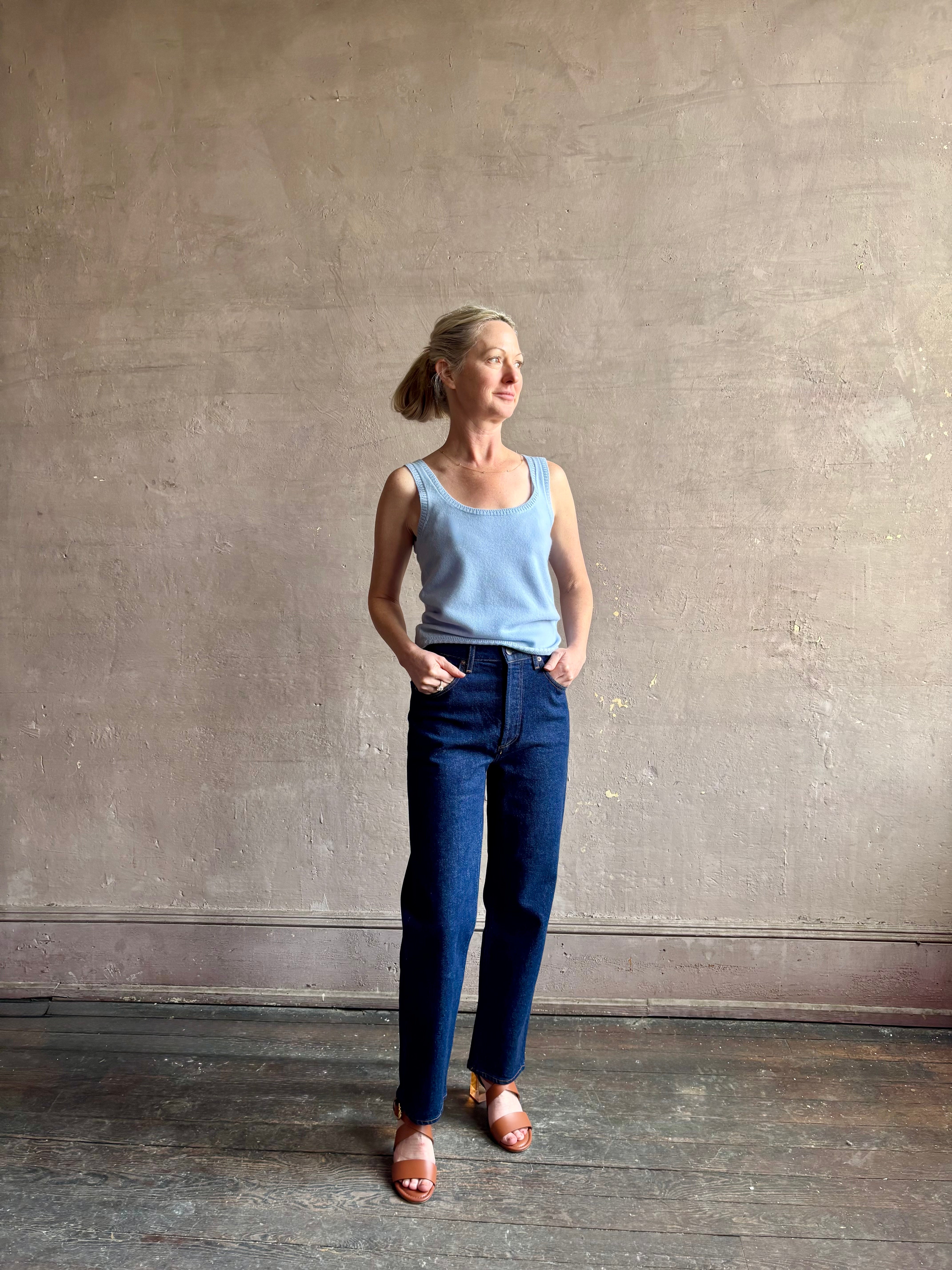 Image of woman wearing luxury cashmere knitwear Tanya Taylor Rory Cashmere Tank top in Pale Blue with a feminine scoop neckline 