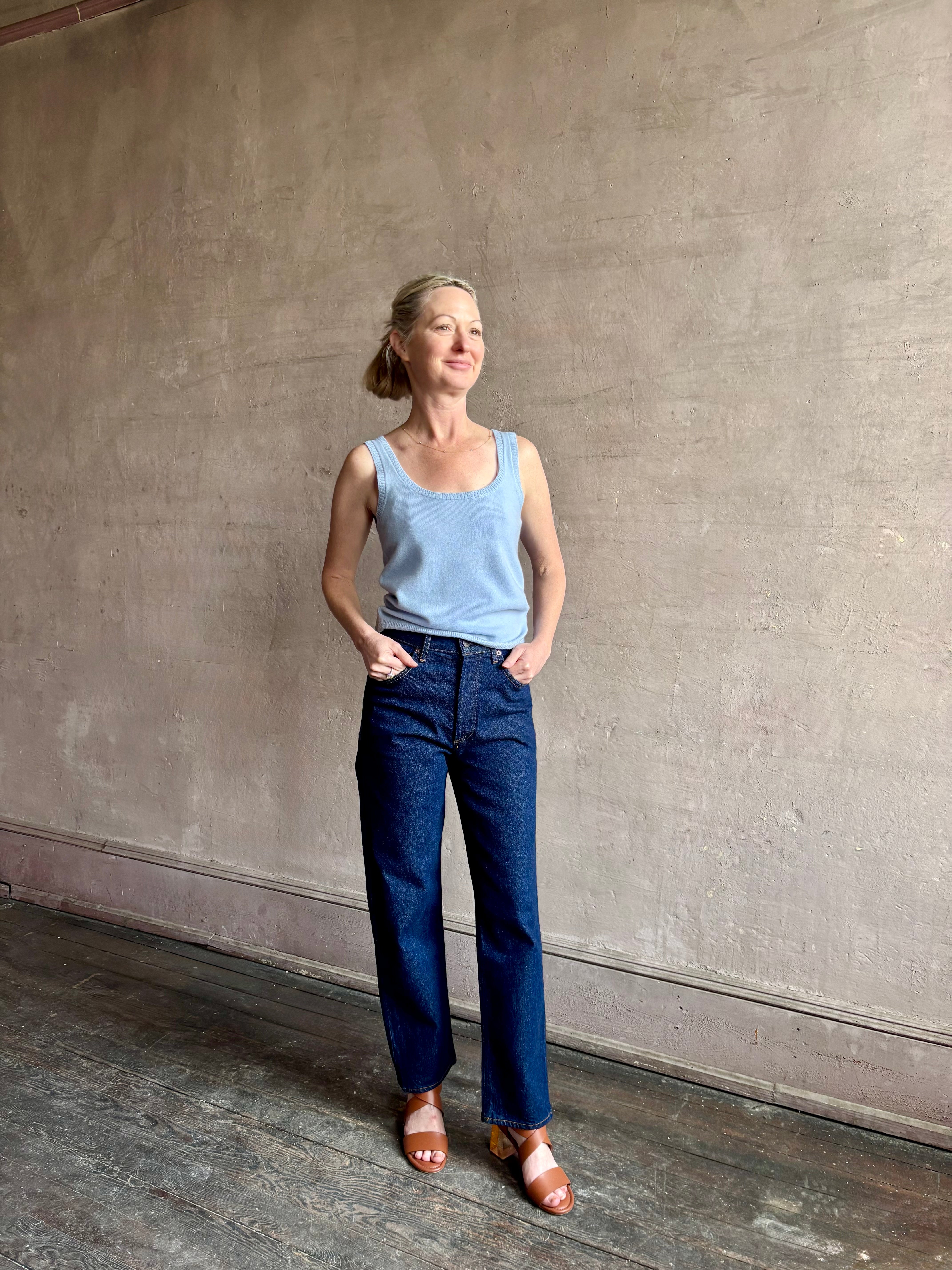 Image of woman wearing luxury cashmere knitwear Tanya Taylor Rory Cashmere Tank top in Pale Blue with a feminine scoop neckline 