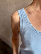 Image of woman wearing luxury cashmere knitwear Tanya Taylor Rory Cashmere Tank top in Pale Blue with a feminine scoop neckline 