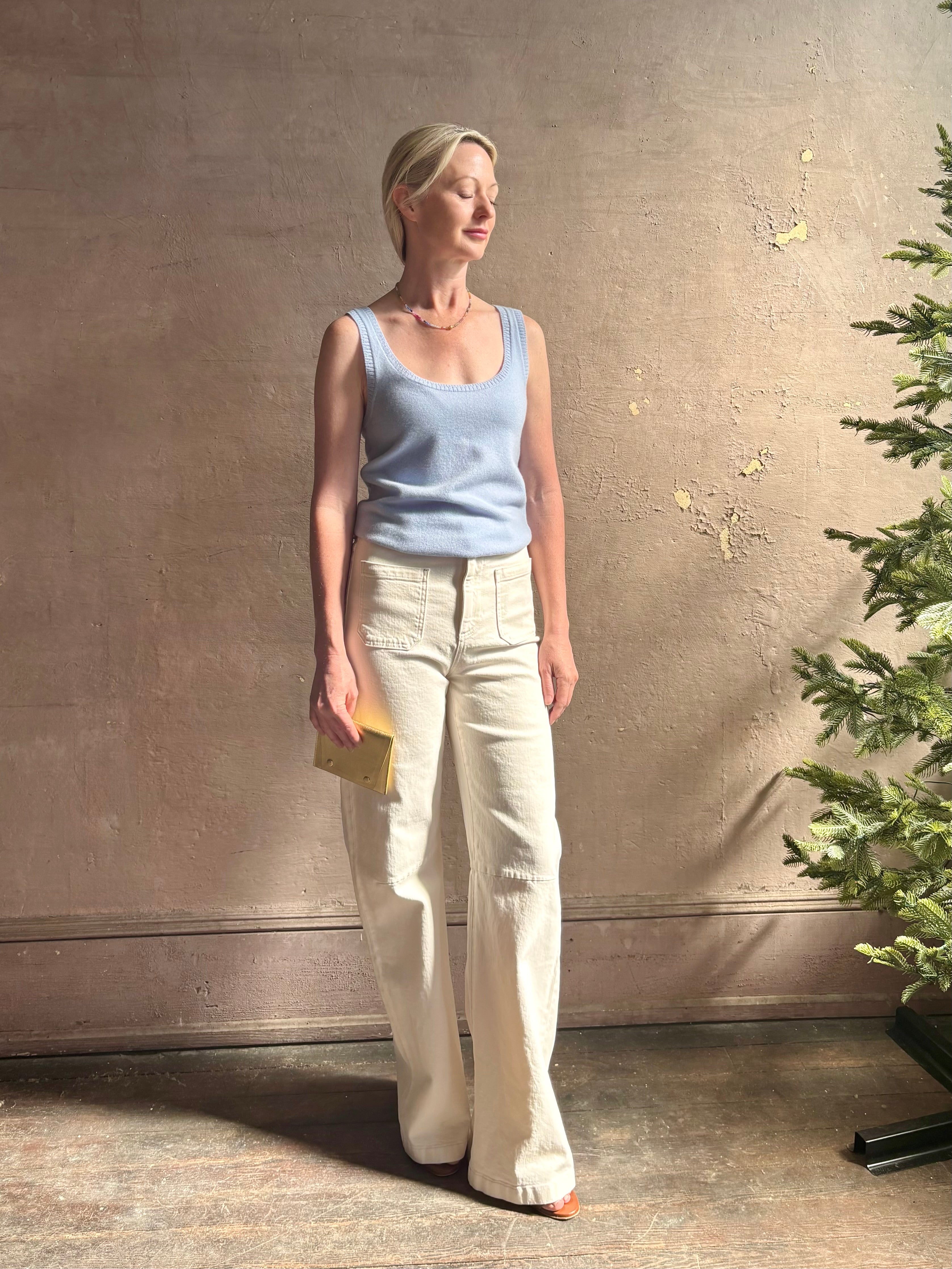 Image of woman wearing luxury cashmere knitwear Tanya Taylor Rory Cashmere Tank top in Pale Blue with a feminine scoop neckline