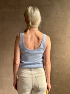 Image of woman wearing luxury cashmere knitwear Tanya Taylor Rory Cashmere Tank top in Pale Blue with a feminine scoop neckline