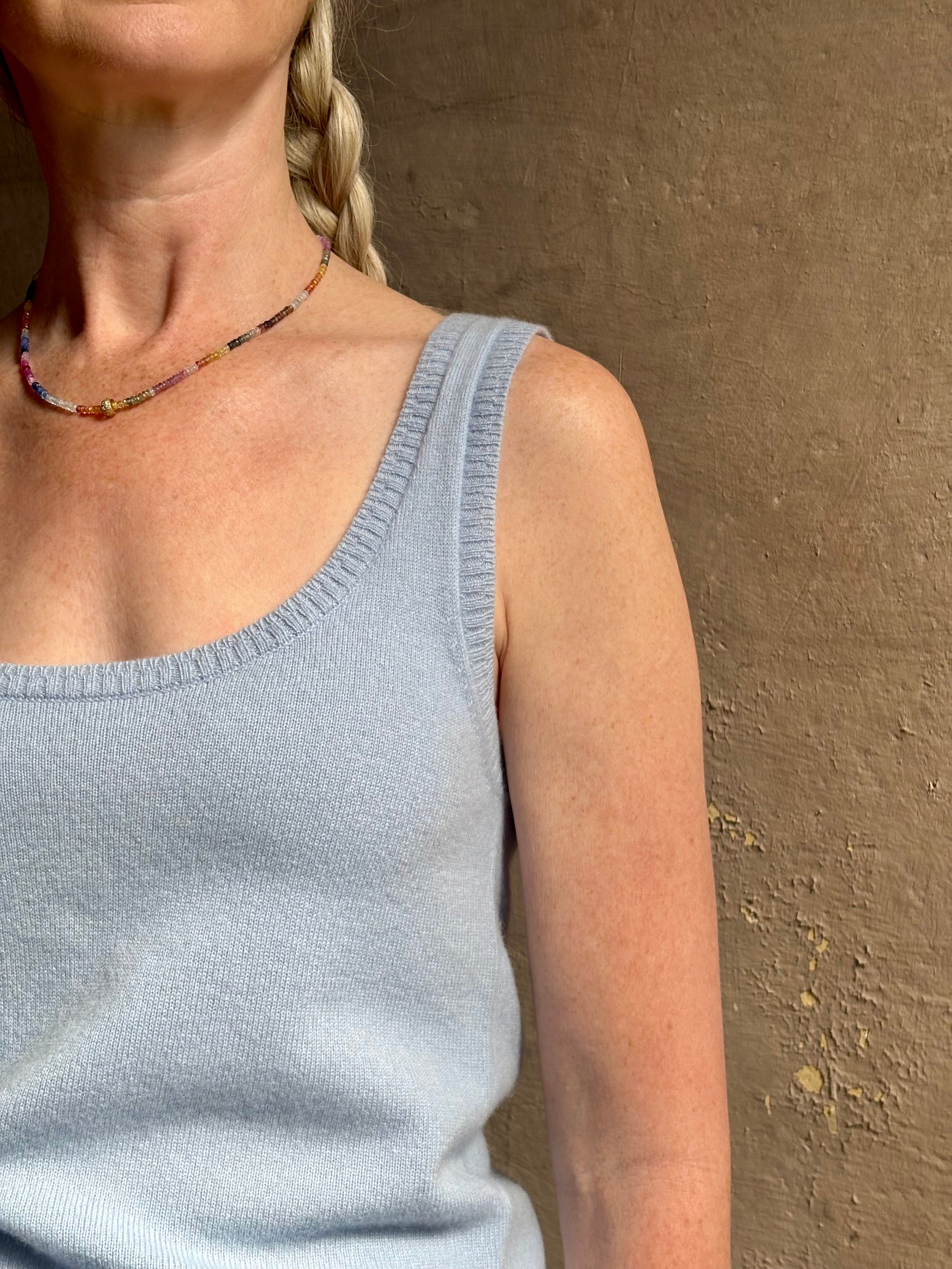 Image of woman wearing luxury cashmere knitwear Tanya Taylor Rory Cashmere Tank top in Pale Blue with a feminine scoop neckline