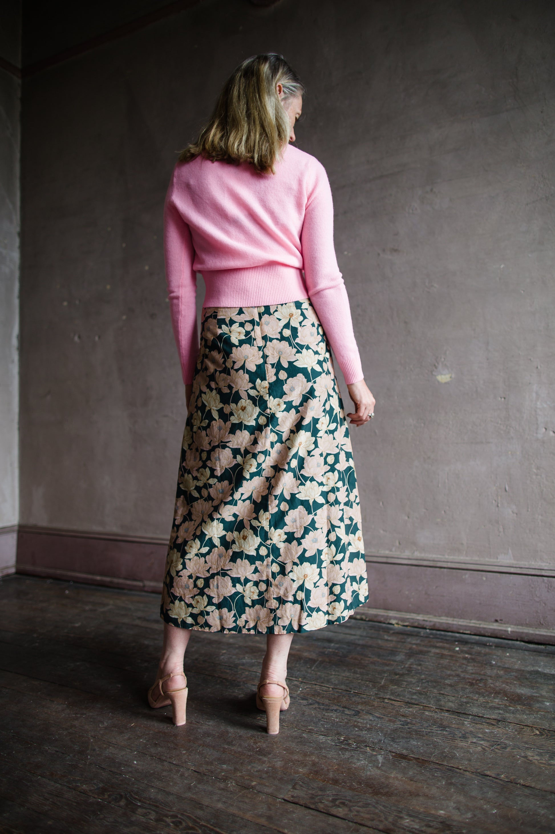 Image featuring a woman wearing the Demi Floral skirt by Trovata with a high rise and a-line fit in a beautiful floral pattern.