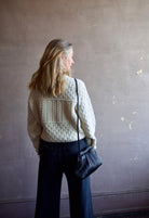 Mature woman wearing the Lara sweater by Trovata with a crew neckline and blocked woven texture in cream.