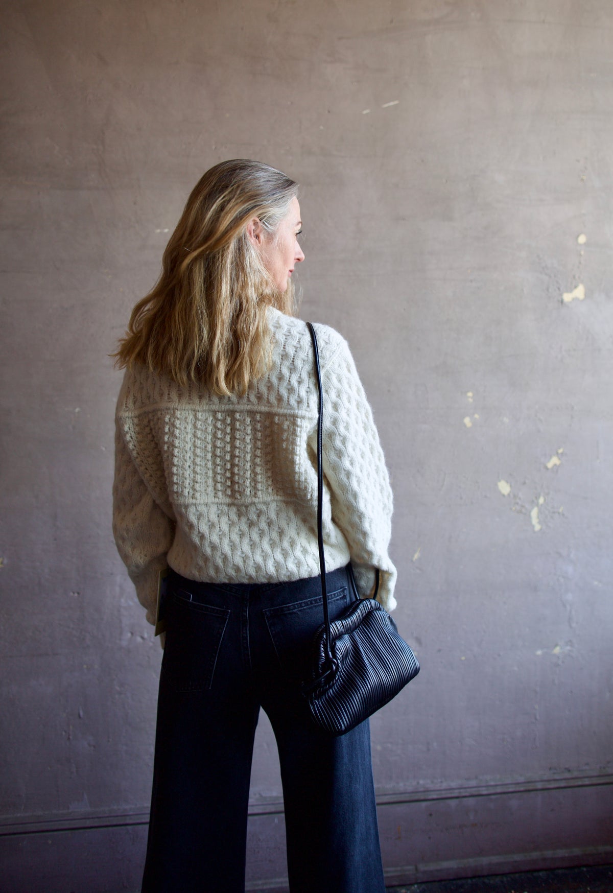 Mature woman wearing the Lara sweater by Trovata with a crew neckline and blocked woven texture in cream.