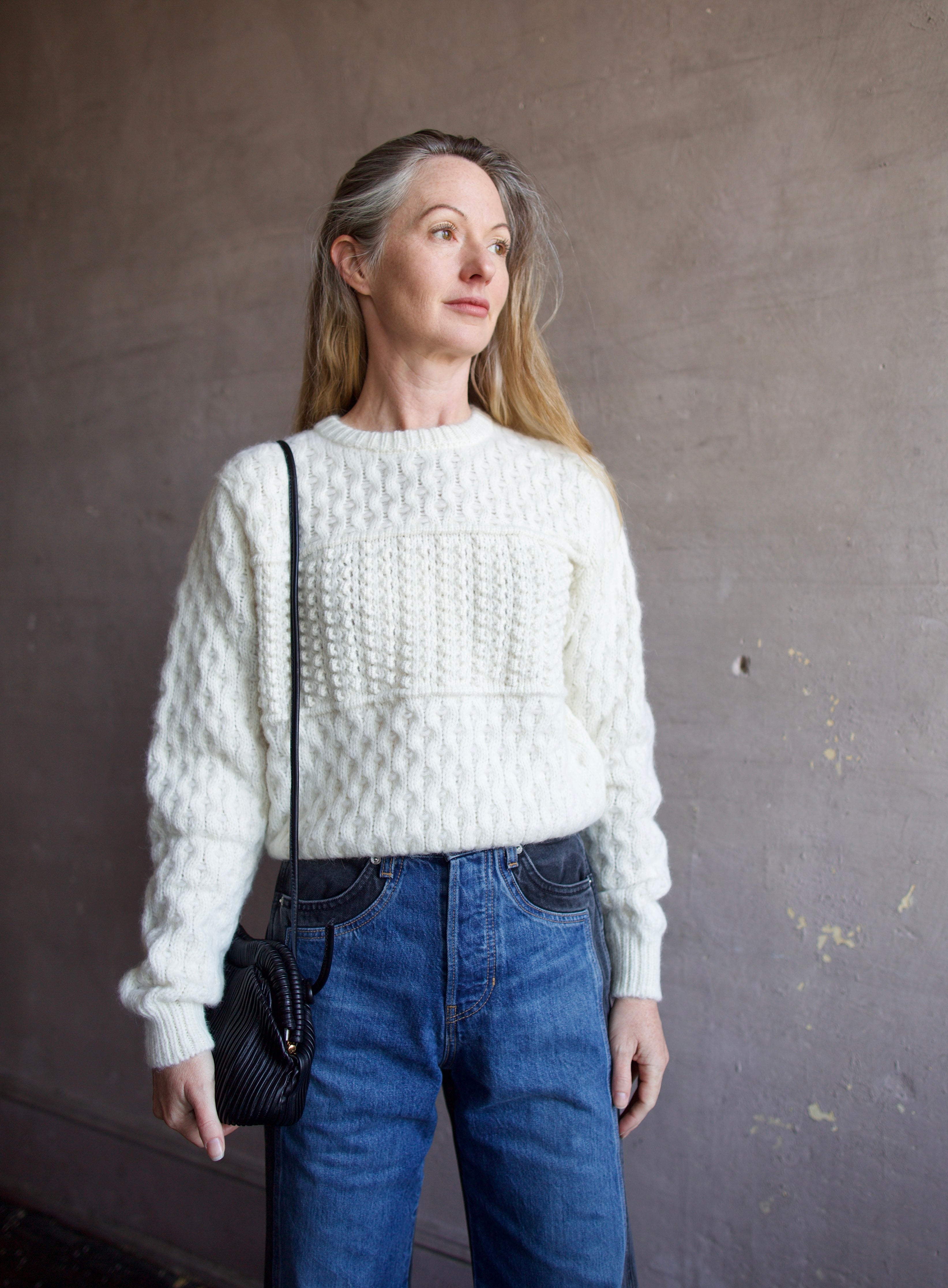 Image featuring a woman wearing the Lara sweater by Trovata with a crew neckline and blocked woven texture in cream.