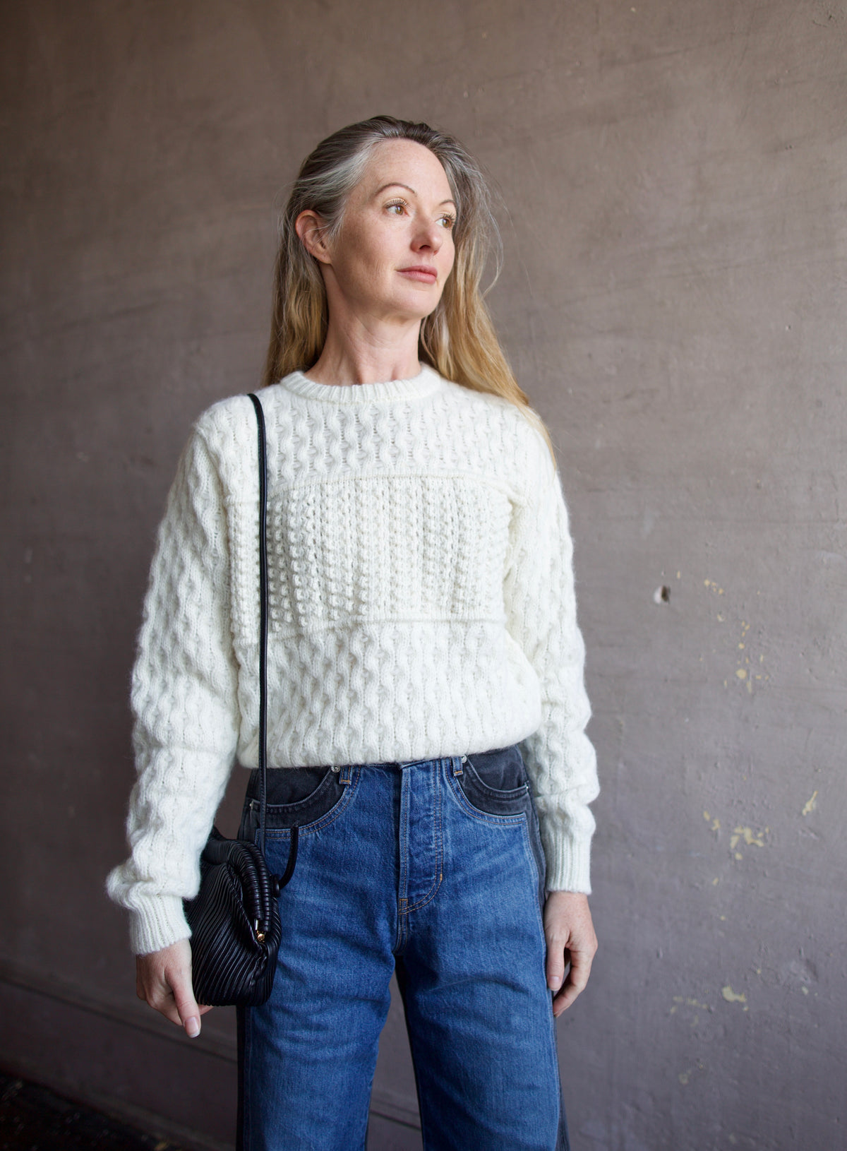 Mature woman wearing the Lara sweater by Trovata with a crew neckline and blocked woven texture in cream.
