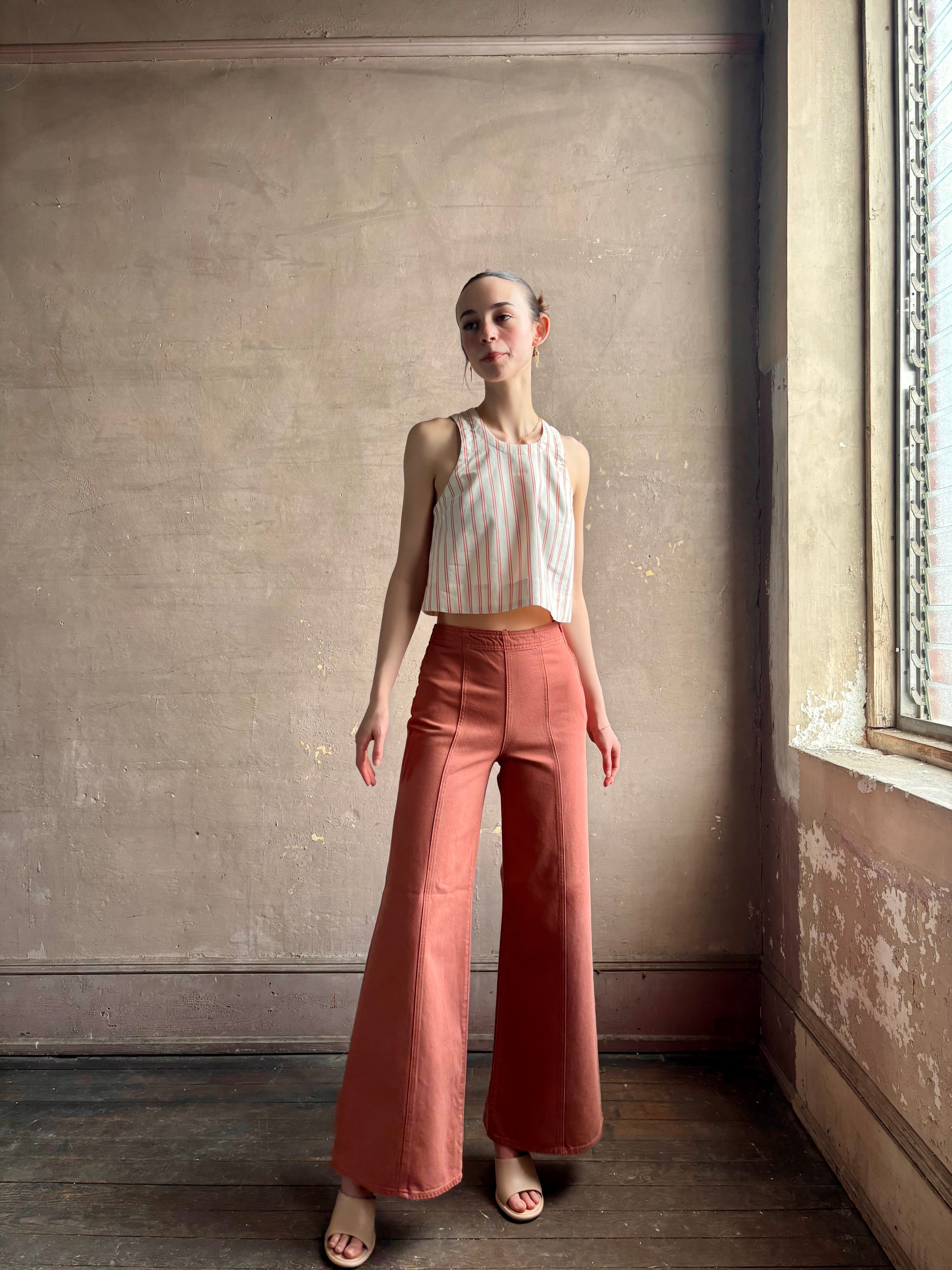 Woman wearing premium elevated casual wear Trovata Esther crew neck sleeveless cotton poplin crop top in cream and rose stripe