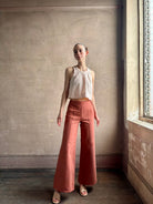 Woman wearing premium elevated casual wear Trovata Esther crew neck sleeveless cotton poplin crop top in cream and rose stripe