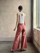 Woman wearing premium elevated casual wear Trovata Esther crew neck sleeveless cotton poplin crop top in cream and rose stripe