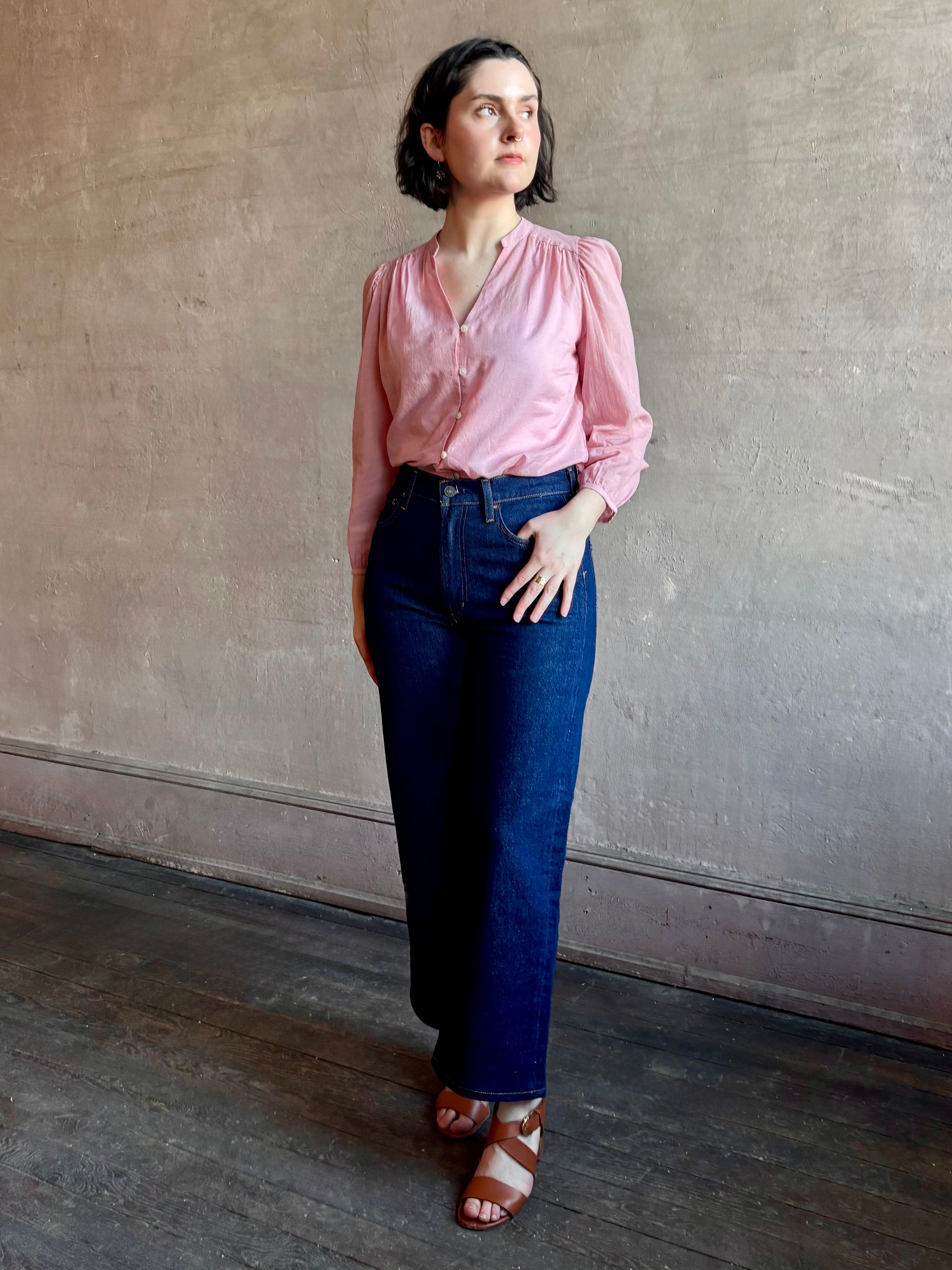 woman wearing premium lightweight cotton poplin Maisey Blouse by Trovata with long sleeves and v-neck in pink and white tiny Houndstooth print