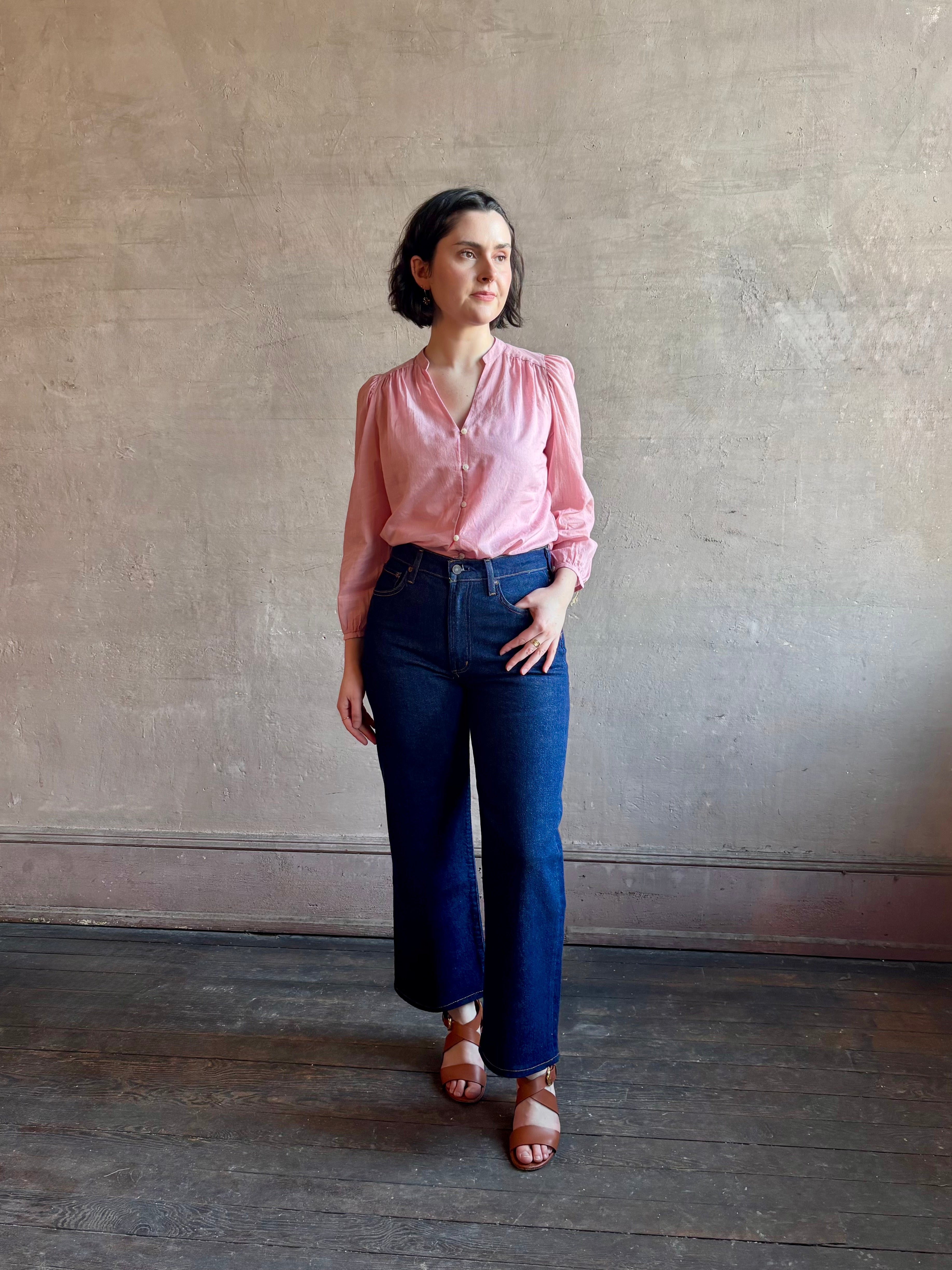 Woman wearing premium lightweight cotton poplin Maisey Blouse by Trovata with long sleeves and v-neck in pink and white tiny Houndstooth print