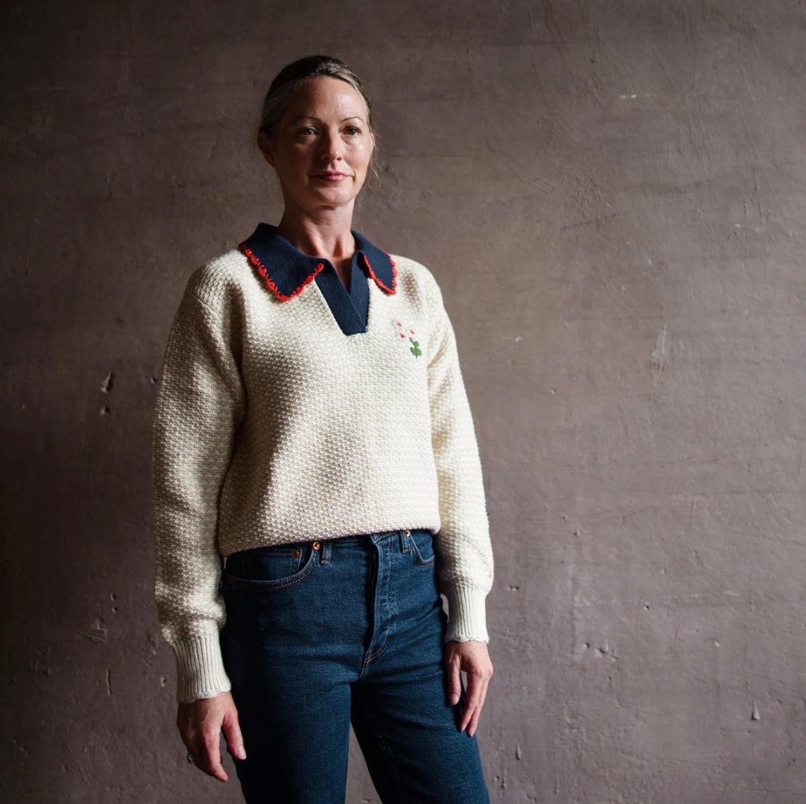 Image featuring a woman wearing Trovata's Parker Polo Sweater is a long sleeve polo with a v-neckline, classic shirt collar and subtle hem in a cotton blend.