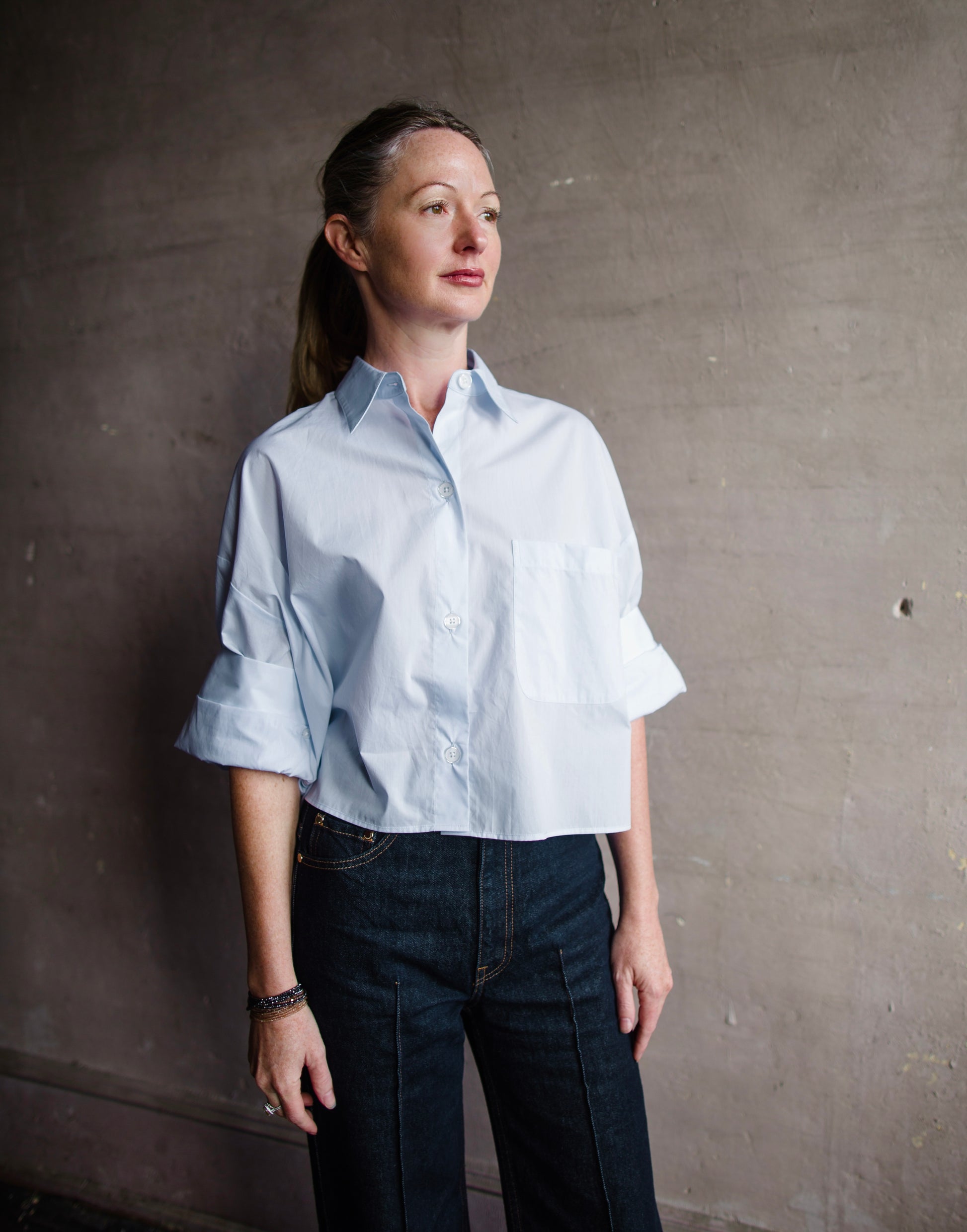 Image featuring a woman wearing TWP next ex shirt in baby blue color fabricated from 100% superfine cotton.