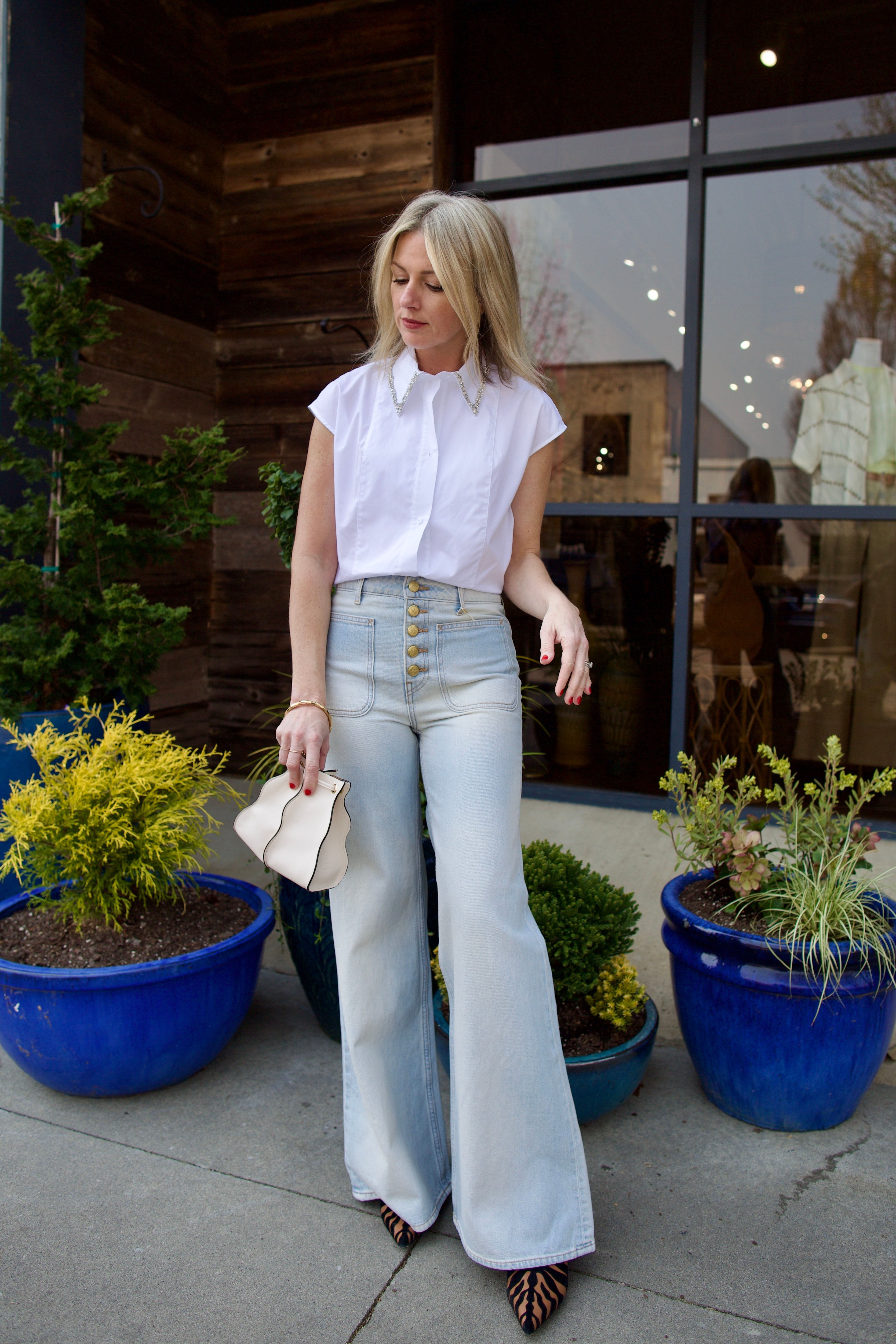 Mature model wearing luxury brand TWP white cap sleeve top with detachable crystal beaded collar in premium cotton 