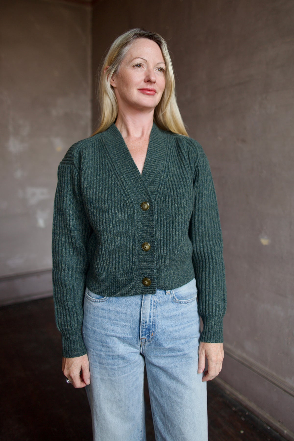 Mature woman wearing TWP Cropped Cardigan in Duffle Bag ribbed cashmere substantial everyday luxury layering