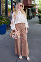Woman wearing Veronica Beard Taylor Cropped Jeans in Hazelnut stone sophisticated lattice texture wide leg