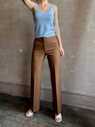 Woman wearing premium wool tailored blanca trousers by luxury designer Ulla Johnson neutral warm brown