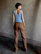 Woman wearing premium wool tailored blanca trousers by luxury designer Ulla Johnson neutral warm brown