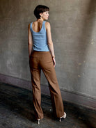 Woman wearing premium wool tailored blanca trousers by luxury designer Ulla Johnson neutral warm brown
