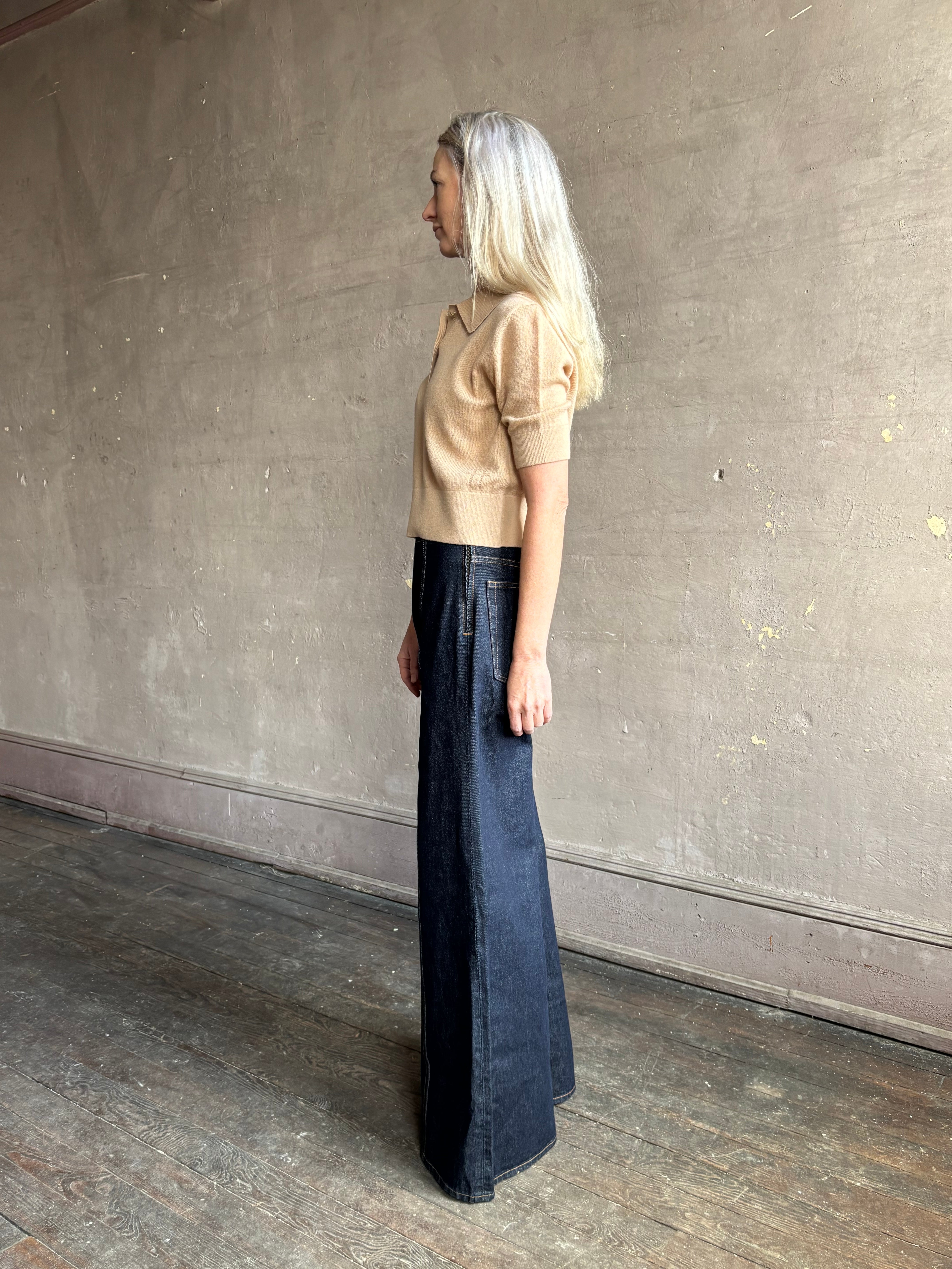 Woman wearing ULLA JOHNSON Bianca dark wash rigid Jean with hidden side zip 12" rise and finished hem