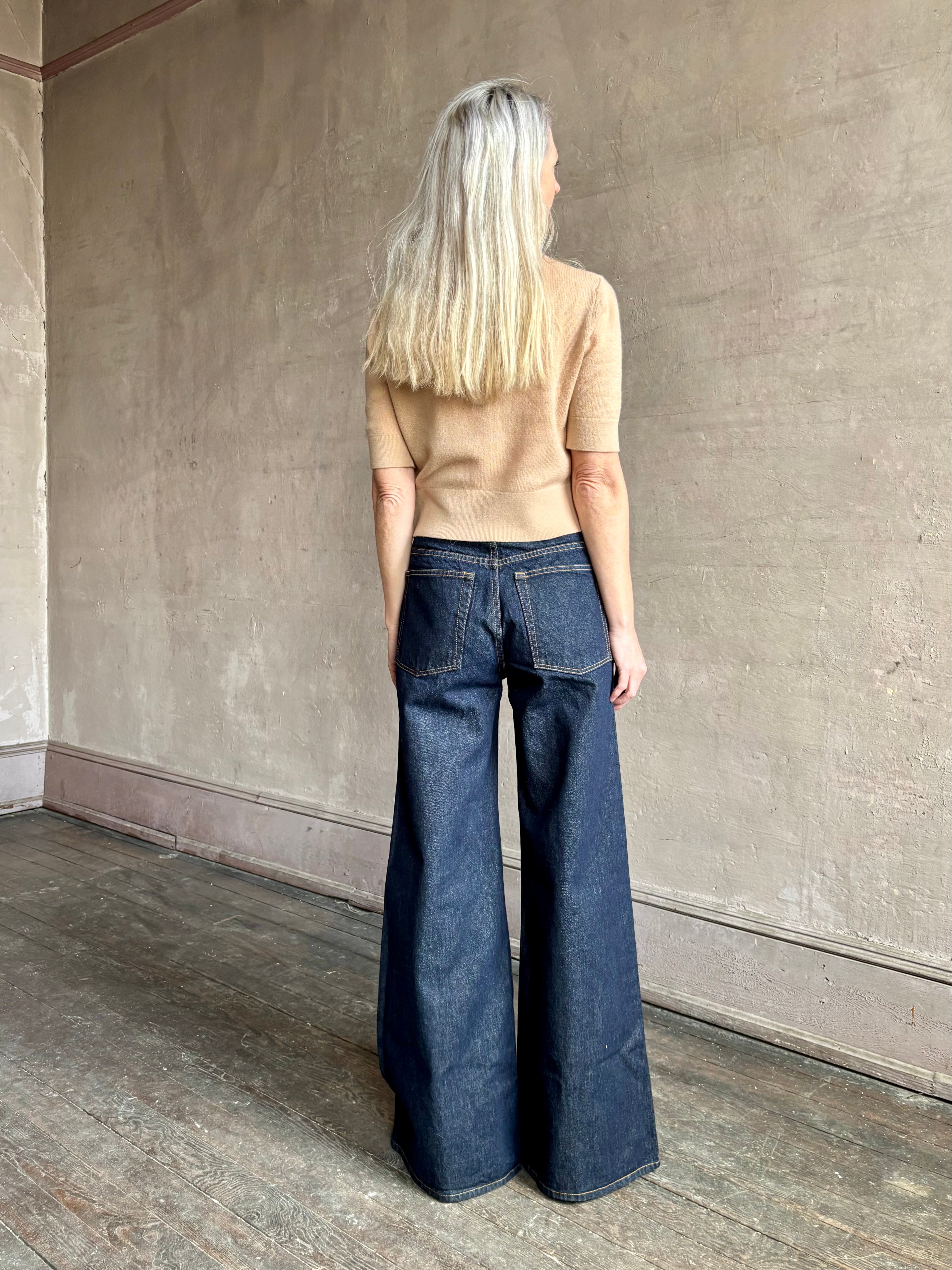 Woman wearing ULLA JOHNSON Bianca dark wash rigid Jean with back pockets and leather Ulla tag