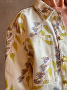 Woman wearing designer ULLA JOHNSON Bobbi denim Jacket in an artisan collaboration print Infinite Flower