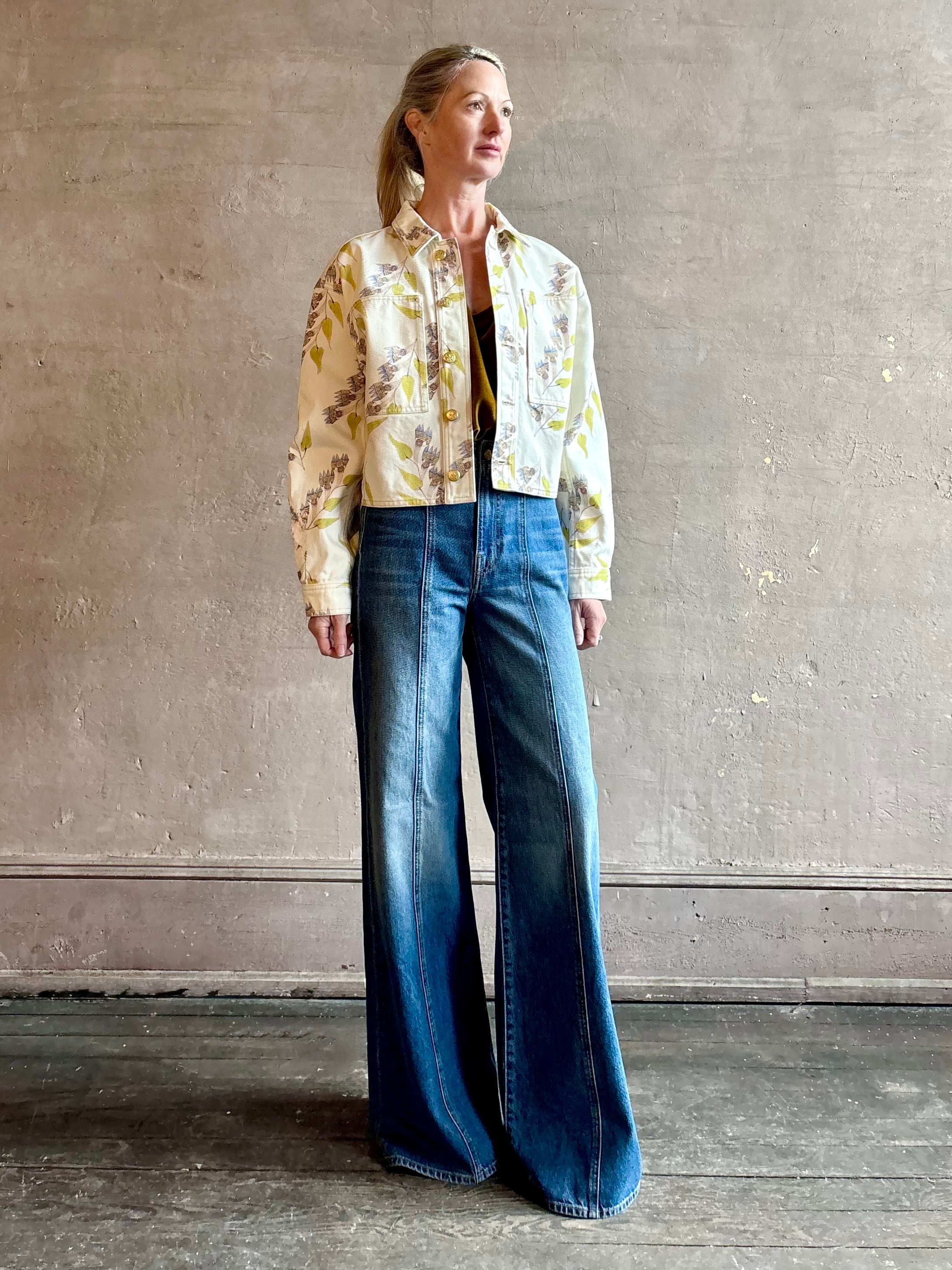 Woman wearing designer ULLA JOHNSON Bobbi denim Jacket in an artisan collaboration print Infinite Flower