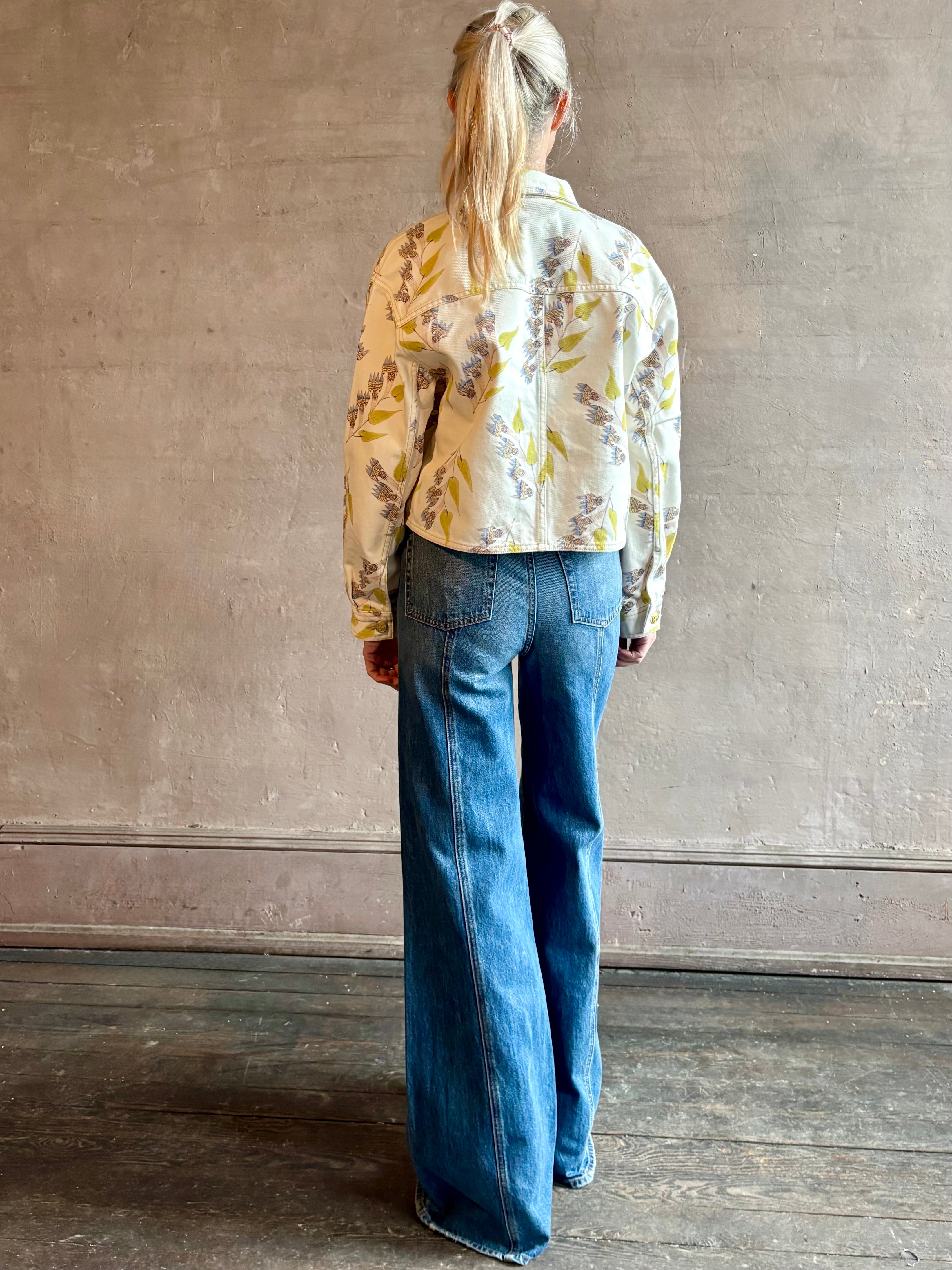 Woman wearing designer ULLA JOHNSON Bobbi denim Jacket in an artisan collaboration print Infinite Flower