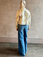 Woman wearing designer ULLA JOHNSON Bobbi denim Jacket in an artisan collaboration print Infinite Flower