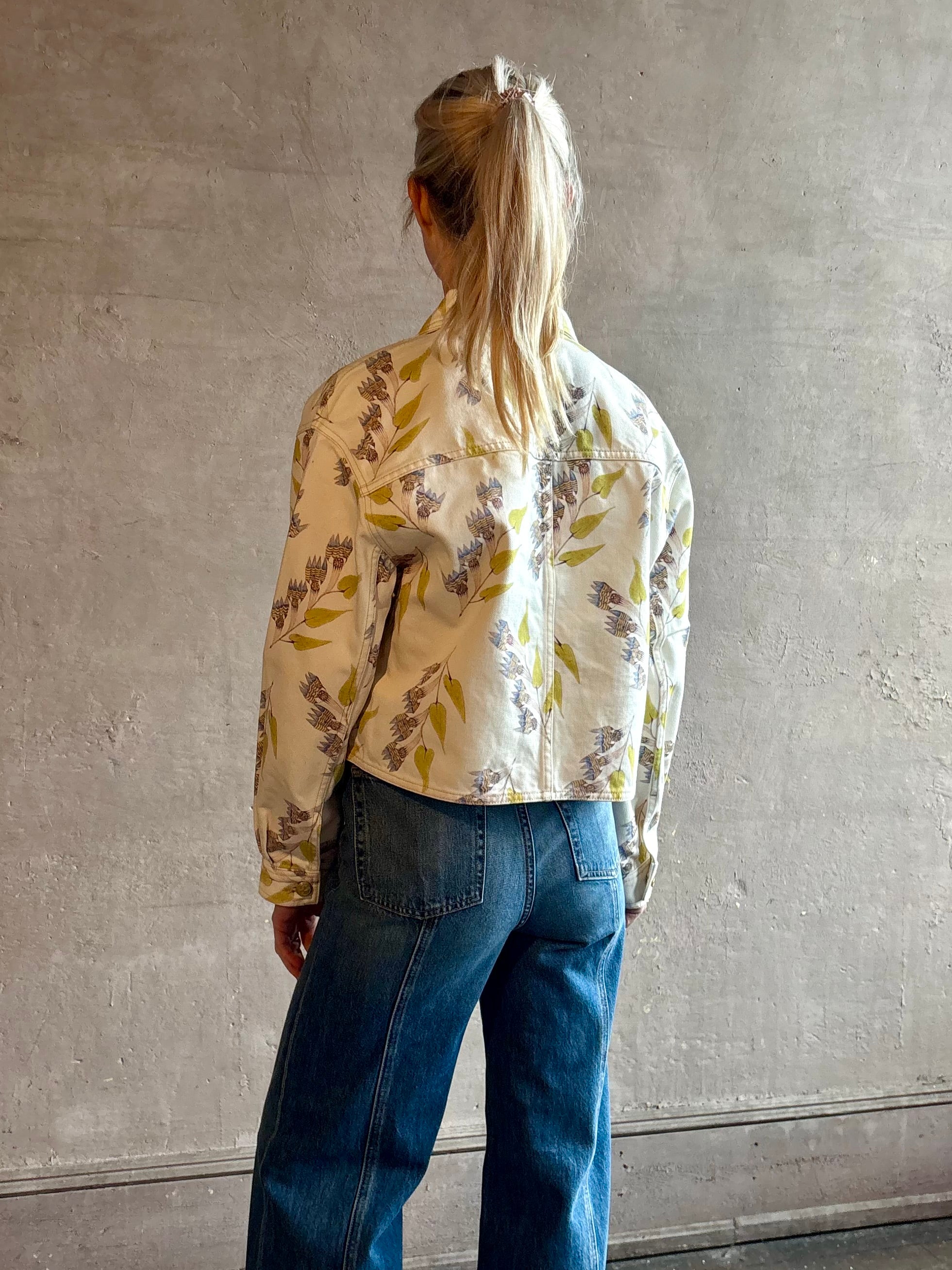 Woman wearing designer ULLA JOHNSON Bobbi denim Jacket in an artisan collaboration print Infinite Flower 