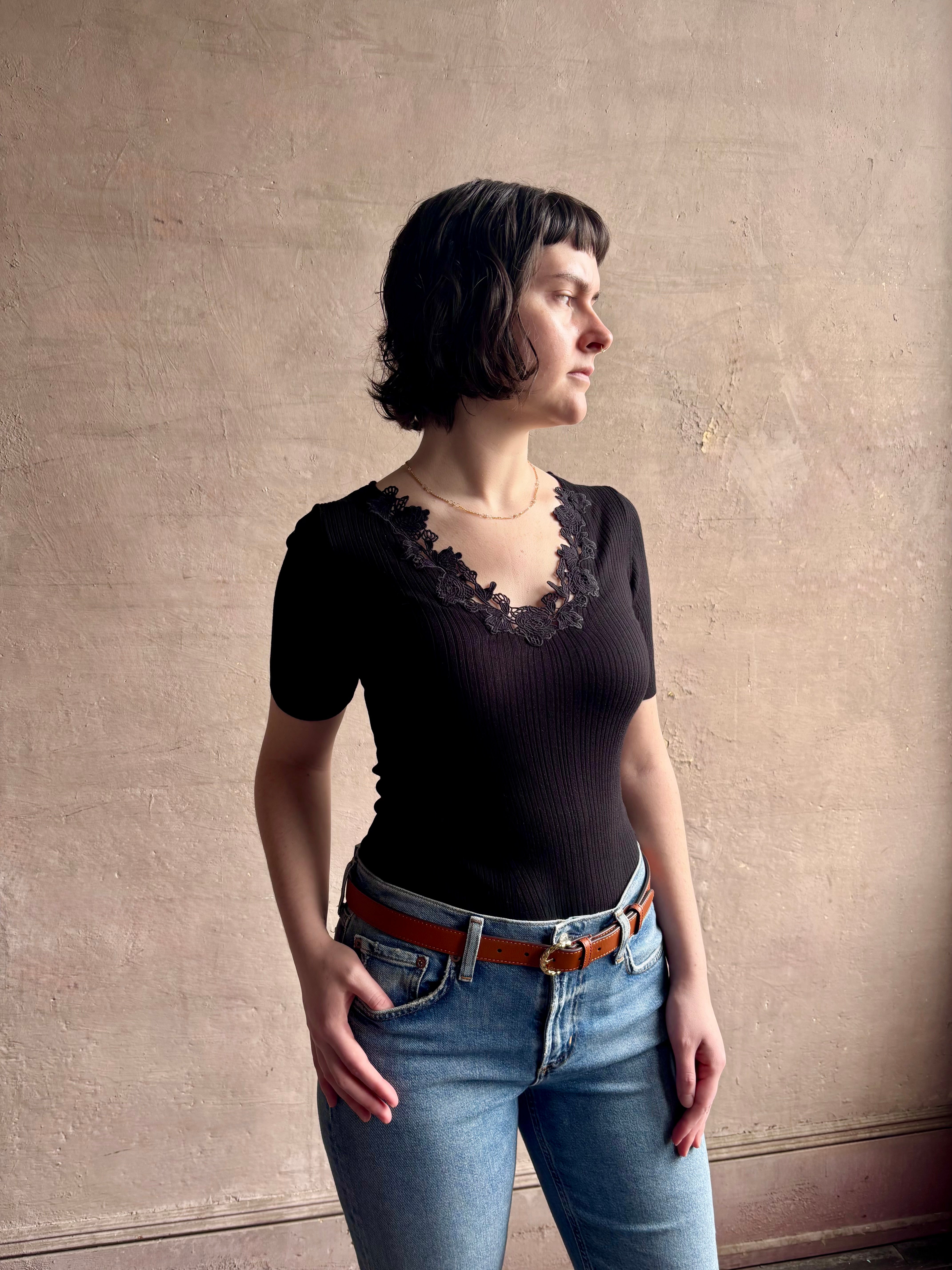 Woman wearing the Celeste Short Sleeve Knit Top with Lace from Ulla Johnson with cotton lace lined v- neck, short sleeves and fitted body