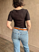 Woman wearing the Celeste Short Sleeve Knit Top with Lace from Ulla Johnson with cotton lace lined v- neck, short sleeves and fitted body